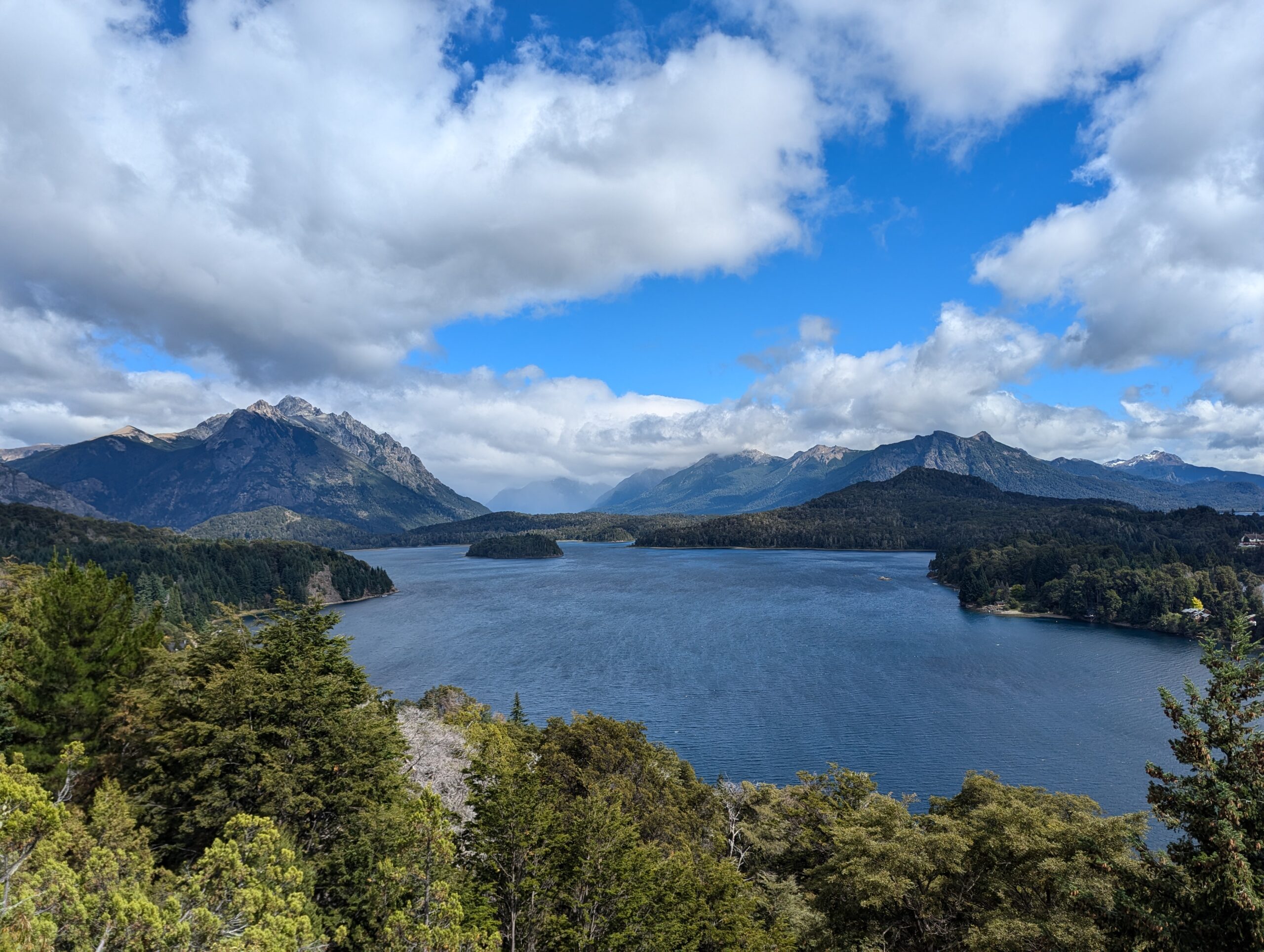 A lake in Bariloche Argentina with vast mountain ranges in the background.